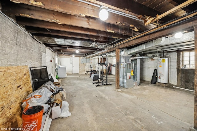 below grade area featuring heating unit, washer / dryer, and water heater