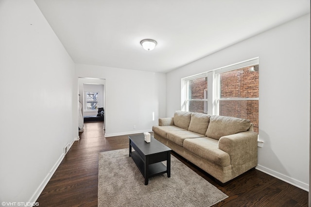 living room with baseboards and dark wood-style floors