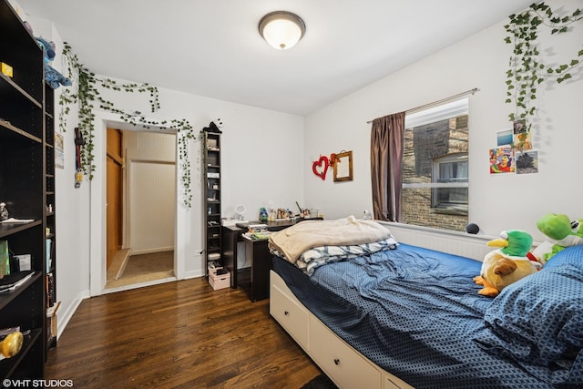 bedroom featuring dark wood finished floors
