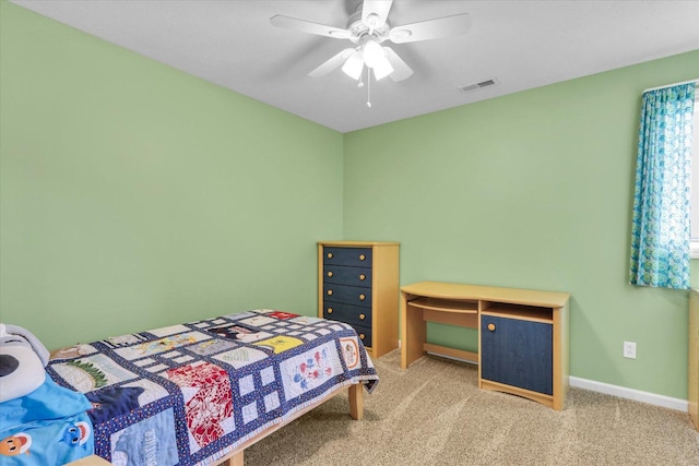 bedroom with baseboards, light carpet, a ceiling fan, and visible vents