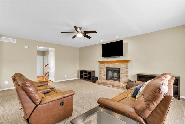 living area featuring ceiling fan, light colored carpet, baseboards, and visible vents