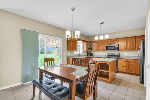 dining space with baseboards, light tile patterned floors, and a chandelier