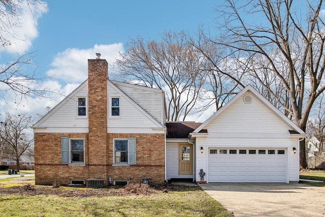 view of front facade featuring driveway, a chimney, an attached garage, brick siding, and central AC unit