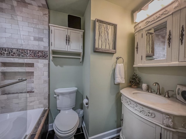 bathroom with toilet, baseboards, tiled shower / bath, and vanity