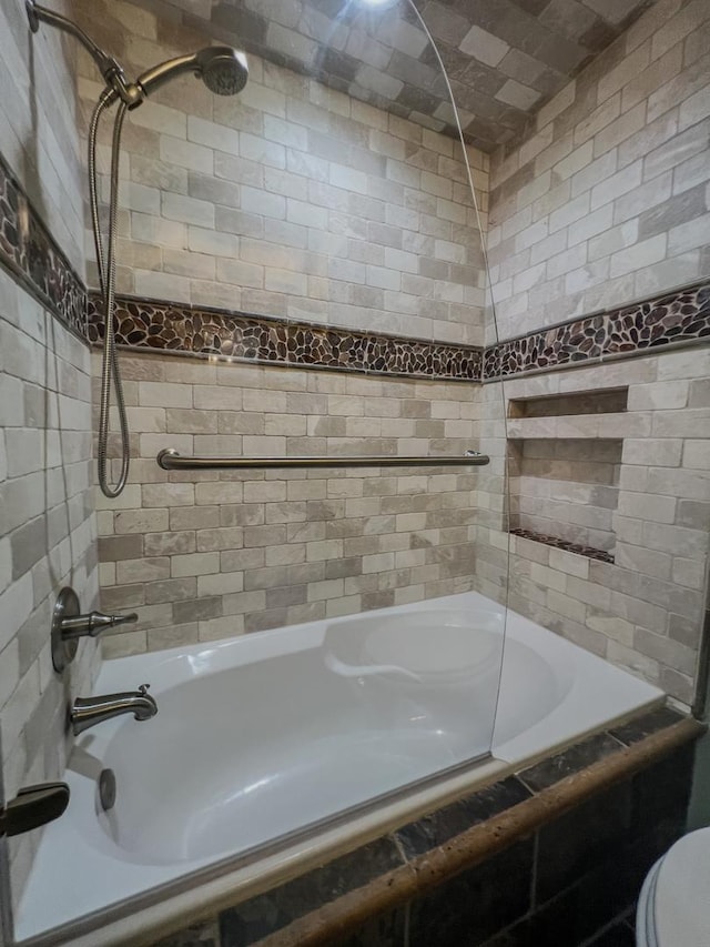 full bath with tiled shower / bath combo and toilet