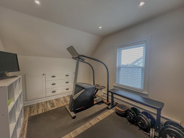 workout area with recessed lighting, light wood-type flooring, and lofted ceiling