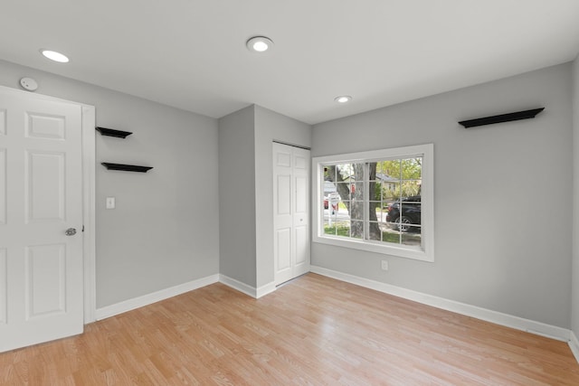 120 Anderson Ave, Joliet, IL 60433 - unfurnished bedroom featuring light wood-style flooring, baseboards, a closet, and recessed lighting
