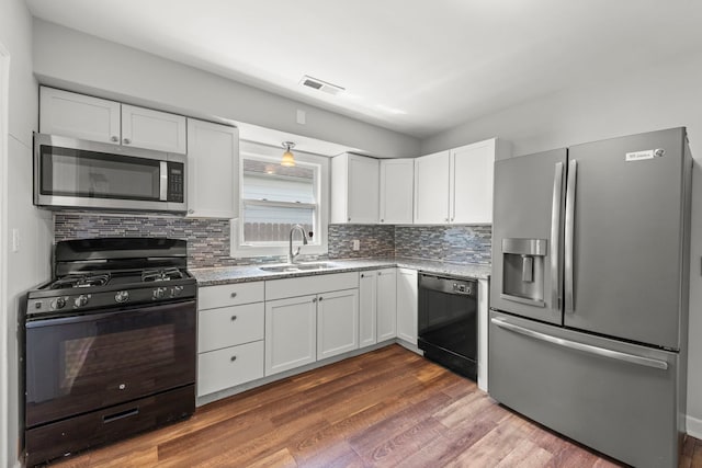 120 Anderson Ave, Joliet, IL 60433 - kitchen featuring black appliances, a sink, white cabinetry, and decorative backsplash