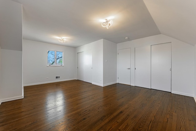 4313 Elm Ave, Lyons, IL 60534 - unfurnished bedroom featuring two closets, dark wood-type flooring, and lofted ceiling