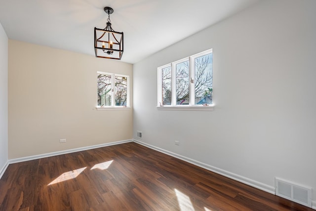 4313 Elm Ave, Lyons, IL 60534 - empty room featuring dark wood-style floors and a chandelier