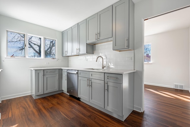 4313 Elm Ave, Lyons, IL 60534 - kitchen with dishwasher, gray cabinets, dark wood finished floors, backsplash, and light countertops