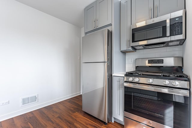 4313 Elm Ave, Lyons, IL 60534 - kitchen with appliances with stainless steel finishes, gray cabinetry, dark wood finished floors, backsplash, and light countertops
