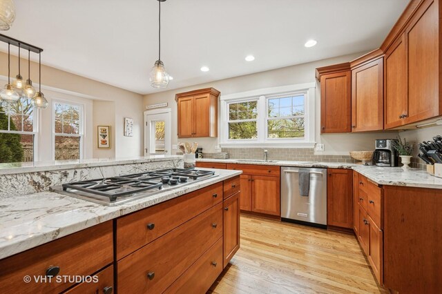 kitchen with recessed lighting, light wood-style flooring, stainless steel appliances, and plenty of natural light