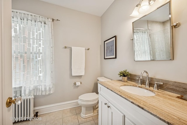 bathroom featuring radiator heating unit, tile patterned floors, vanity, baseboards, and toilet