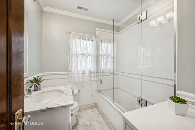 full bathroom featuring tile walls, visible vents, crown molding, tiled shower / bath combo, and vanity