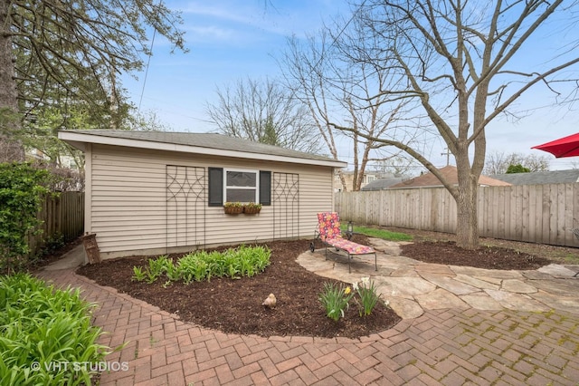 view of outbuilding featuring a fenced backyard and an outbuilding