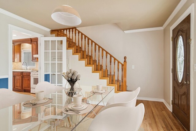 1019 Rockland Rd, Lake Bluff, IL 60044 - dining room featuring crown molding, light wood-style floors, and stairway