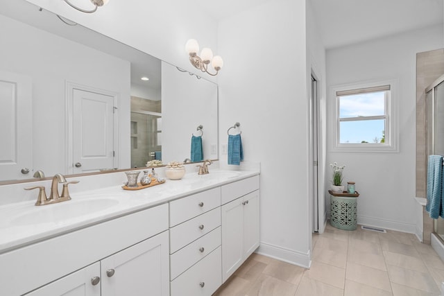 full bathroom featuring double vanity, a sink, baseboards, and a shower stall