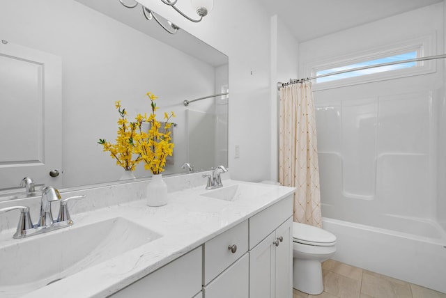 full bathroom featuring toilet, a sink, double vanity, and shower / bath combo