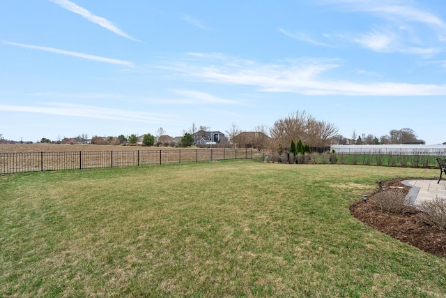view of yard featuring fence and a rural view