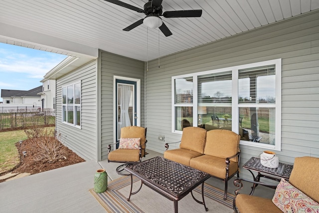 view of patio featuring an outdoor living space, fence, and a ceiling fan