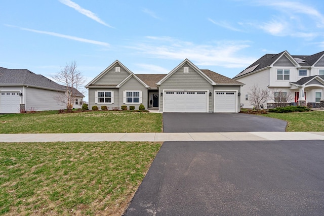 view of front of property featuring driveway, a front yard, and a garage