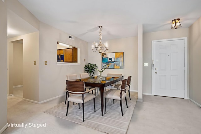 326 Park Ave Unit 43, Clarendon Hills, IL 60514 - dining area with a chandelier and light colored carpet