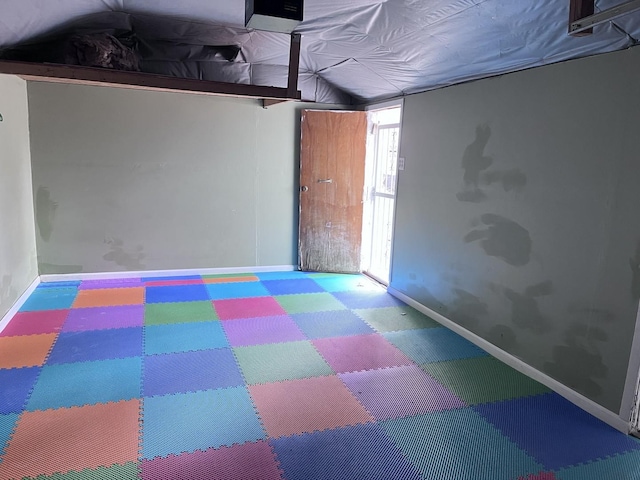 basement featuring tile patterned floors and baseboards