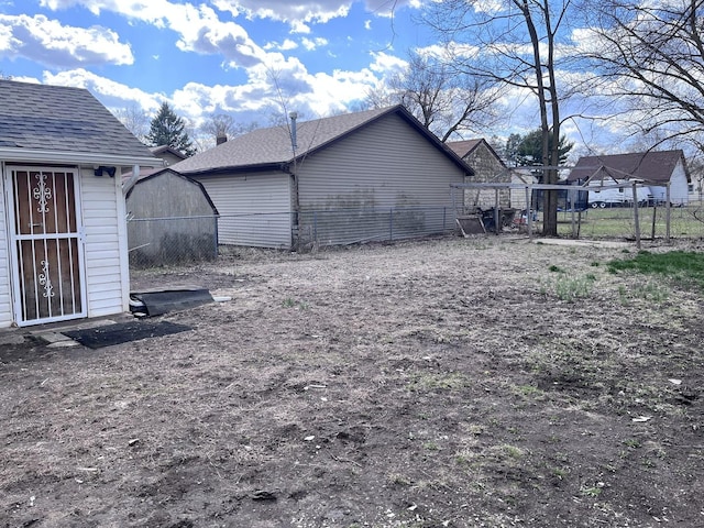 view of yard featuring an outbuilding, fence, and a storage shed