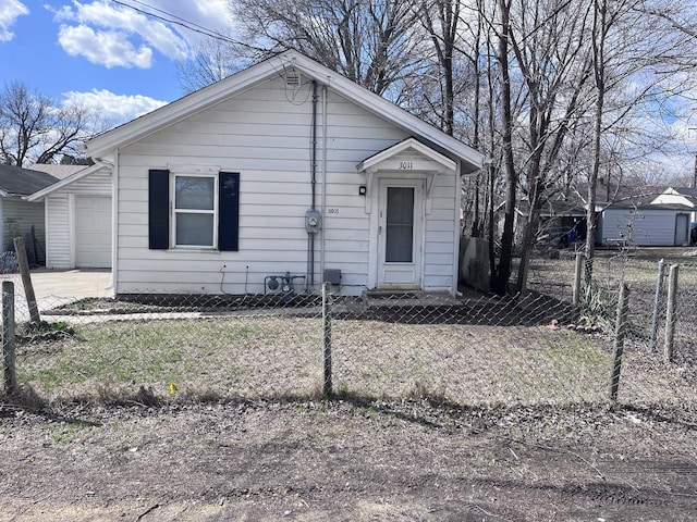 bungalow with driveway and a fenced front yard