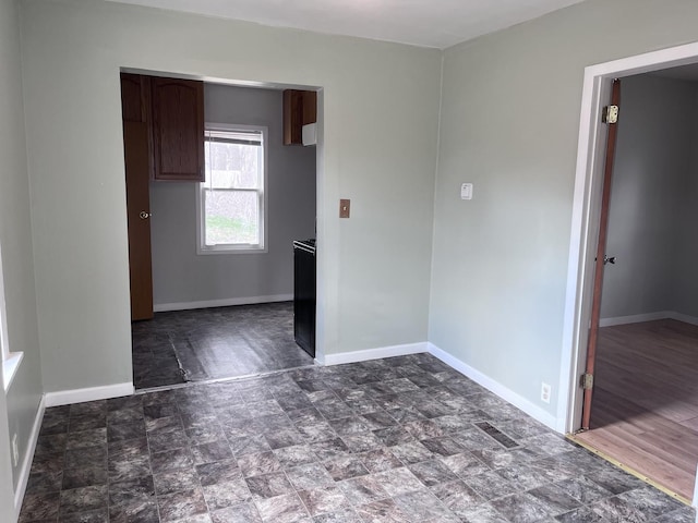 unfurnished bedroom featuring baseboards, visible vents, and stone finish flooring