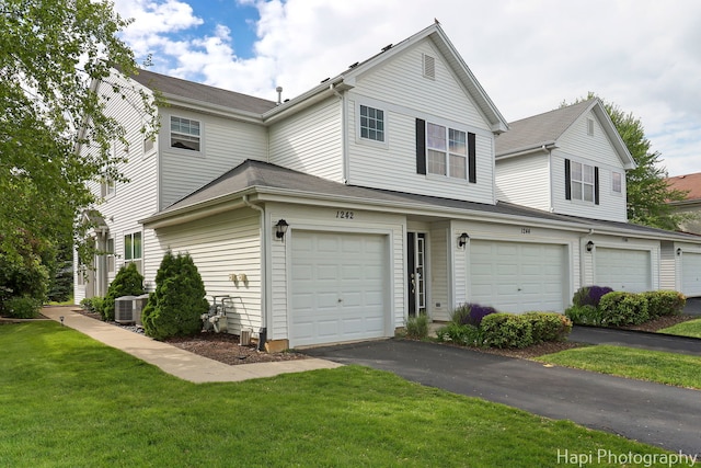 1242 Chesterton Dr Unit 2, Fox Lake, IL 60020 - view of front of property with a front lawn, an attached garage, driveway, and central AC