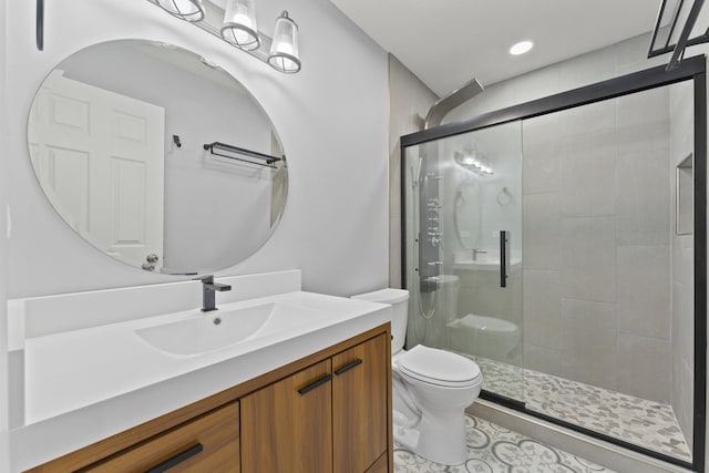 bathroom featuring a shower stall, toilet, and vanity
