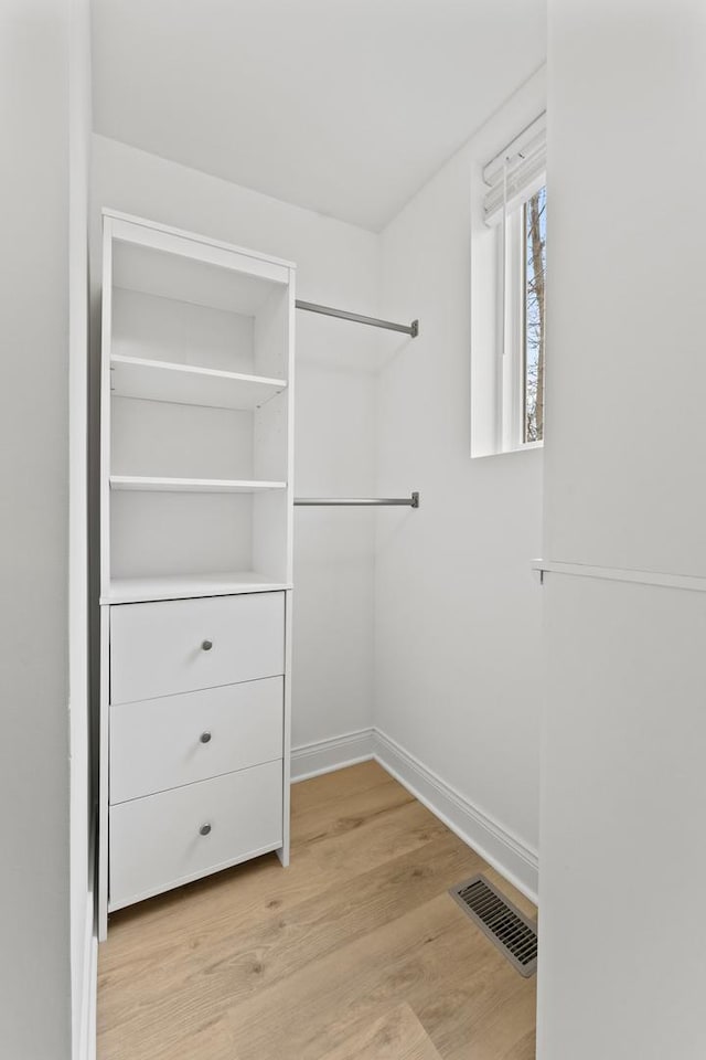 walk in closet featuring light wood-style flooring and visible vents