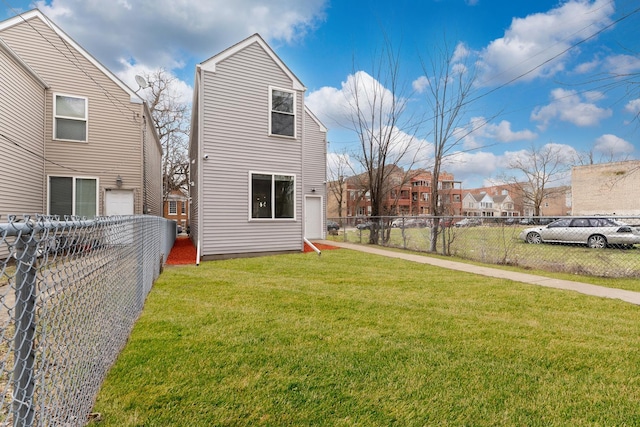 rear view of property with fence private yard and a yard