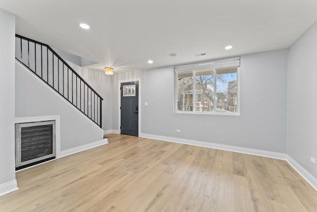 entryway featuring visible vents, baseboards, stairs, wood finished floors, and recessed lighting