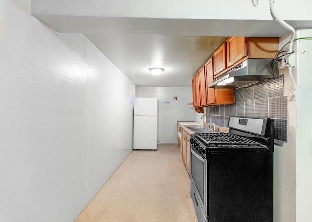 3134 W 39th Pl, Chicago, IL 60632 - kitchen with freestanding refrigerator, stainless steel gas stove, under cabinet range hood, backsplash, and light flooring