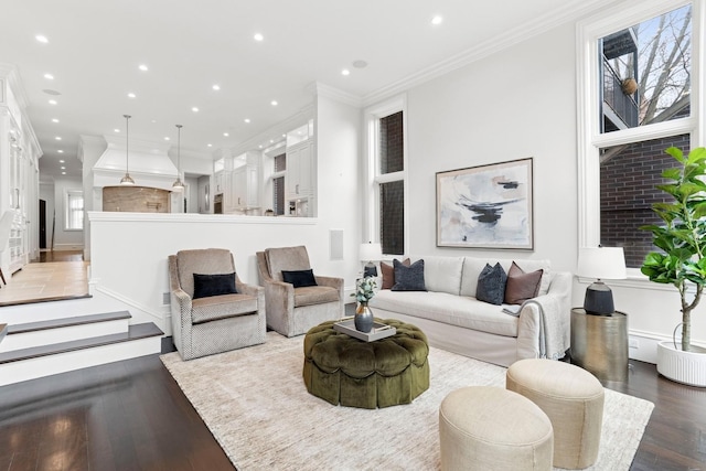 living area with ornamental molding, wood finished floors, and recessed lighting