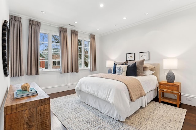 bedroom with dark wood-type flooring, visible vents, recessed lighting, and crown molding