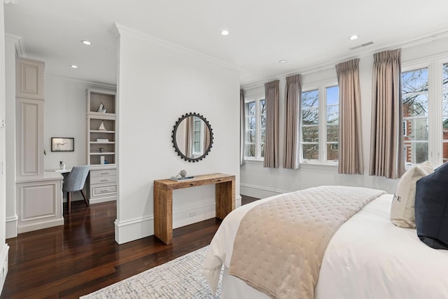bedroom featuring built in study area, visible vents, multiple windows, and wood finished floors