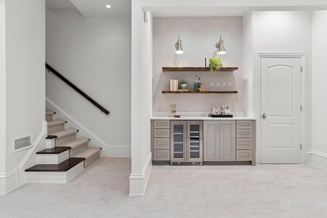bar featuring wet bar, light carpet, beverage cooler, visible vents, and recessed lighting