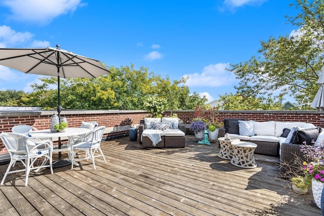wooden terrace with an outdoor hangout area and outdoor dining area
