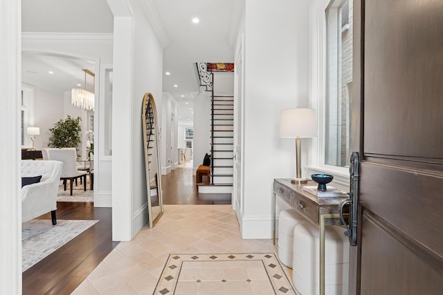 foyer entrance with light tile patterned flooring, crown molding, stairs, and recessed lighting