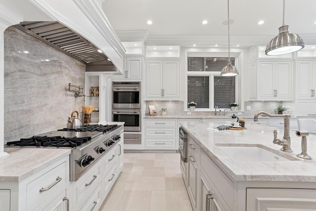 kitchen with decorative backsplash, white cabinetry, a sink, and appliances with stainless steel finishes