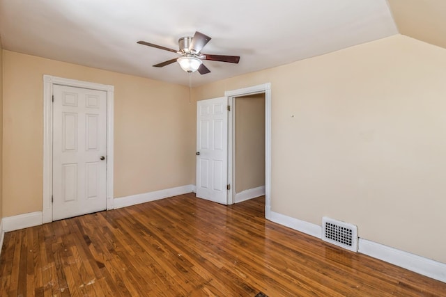 unfurnished bedroom featuring baseboards, visible vents, wood finished floors, and a ceiling fan