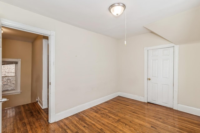 empty room featuring baseboards and wood finished floors