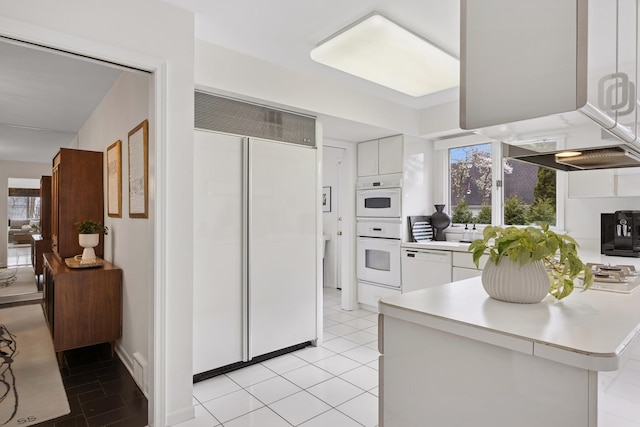 kitchen featuring light countertops, plenty of natural light, white cabinetry, and white appliances