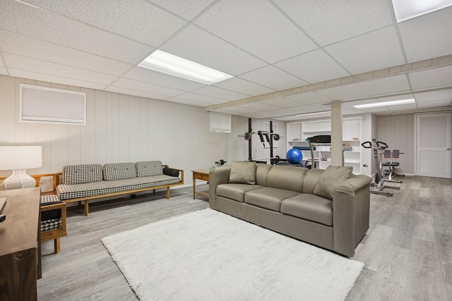 living area with wood finished floors and a drop ceiling