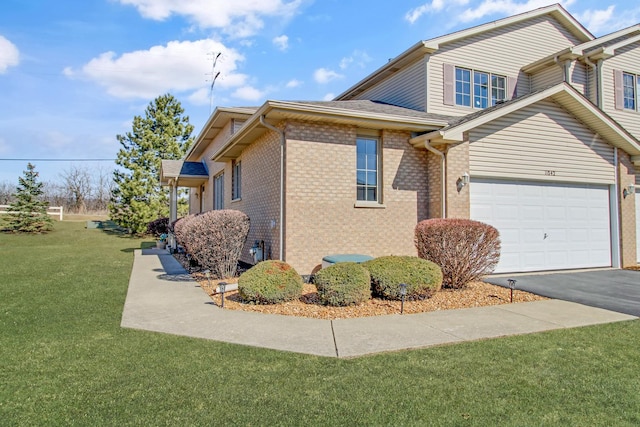 11042 Quail Dr, Mokena, IL 60448 - view of home's exterior featuring a lawn, aphalt driveway, a garage, and brick siding