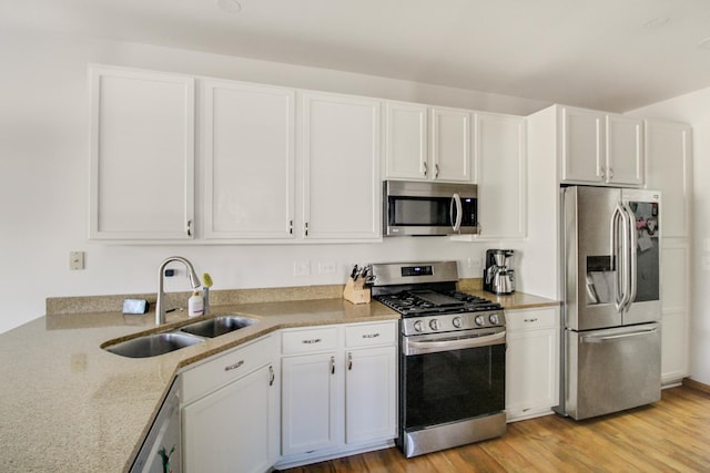 11042 Quail Dr, Mokena, IL 60448 - kitchen featuring a sink, light stone countertops, stainless steel appliances, white cabinets, and light wood-style floors